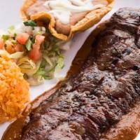 Carne Asada · Charbroiled 9 oz. Skirt steak seasoned in our secret rub and served with a grilled jalapeño ...