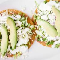 Tostadas · Corn tortillas, freshly fried, topped off with meat, a dab of beans, fresh lettuce, sour cre...