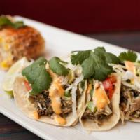 Jerk Chicken Tacos (3) · Pulled jerk chicken in a soft corn tortilla, topped with shredded lettuce, white cheddar, gr...