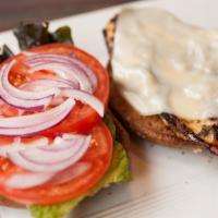 Jerk Chicken Sandwich · Jerk marinated grilled chicken breast topped with lettuce, tomato, onion, & Swiss cheese ser...