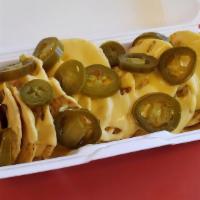 Nachos · Whole tortilla chips, served with a cup of Nacho cheese. Request peppers below.