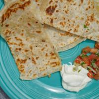 Quesadilla · Chicken or beef with Mexican cheese grilled in a folded flour tortilla