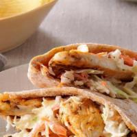Chicken Pita Sandwich · Marinated chicken pieces with mayo, lettuce, tomato, and onions served on a flat pita.