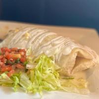 Ohio Burrito · Flour tortilla stuffed with steak or chicken, rice and black beans. Served with lettuce, pic...