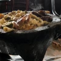 Molcajete Monterrey · Tender slices of steak, chicken, chorizo and shrimp, grilled with Mexican onions and nopal (...