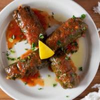 Dolma · Four stuffed grape leaves. Hand-rolled vine leaves stuffed with rice, tomatoes and herbs. Si...