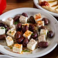 Feta Cheese With Olives · Fresh feta cheese and Kalamata olives, garnished with parsley, sumac, onions and tomatoes. S...