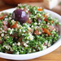 Tabouli Salad · Fresh chopped parsley and tomatoes, mixed with cracked wheat, lemon juice and olive oil.