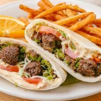Falafel And Hummus Sandwich · A mix of falafel and hummus stuffed in pita and topped with tahini sauce.