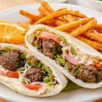 Falafel Sandwich · Delicious falafel patties stuffed in pita and topped with tahini sauce.