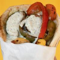 Falafel With Grilled Vegetables Sandwich · Falafel patties and herb spiced grilled vegetables topped with tahini sauce.