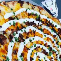 Loaded Baked Potato · Potatoes, bacon, pizza and cheddar cheese, chives, ranch, and sour cream sides.