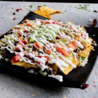Nachos Supreme · lettuce, tomato. Melted Mexican cheese, beans, guacamole,​ sour cream and your choice of meat