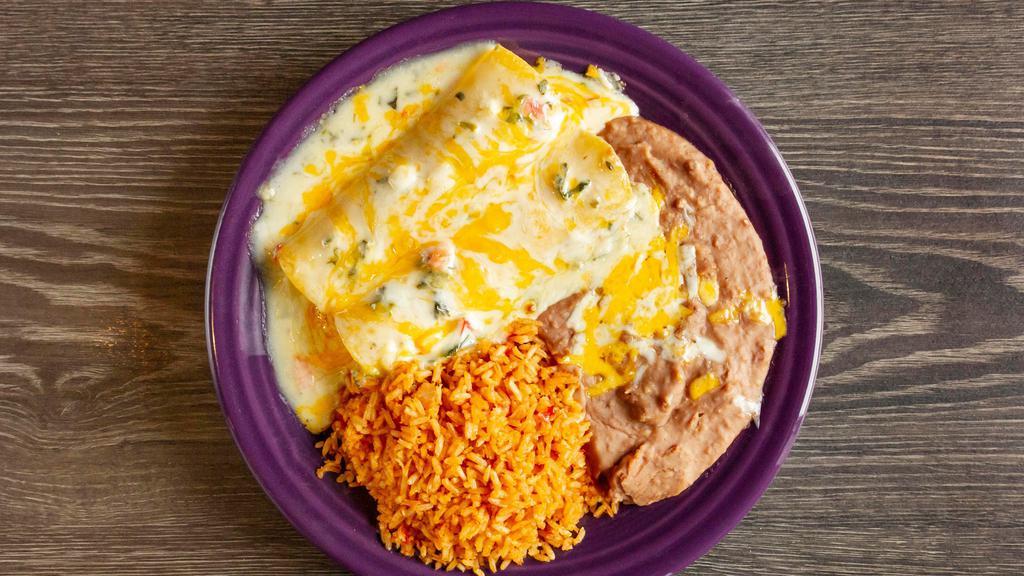 Avocado Enchilada · Vegetarian. Two corn tortillas filled with cheddar and jack cheese, fresh avocados, onions. Topped with espinaca con queso.