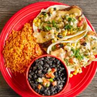 Fish Tacos · Two flour tortillas, grilled tilapia, shredded lettuce, black bean salsa; finished with chip...