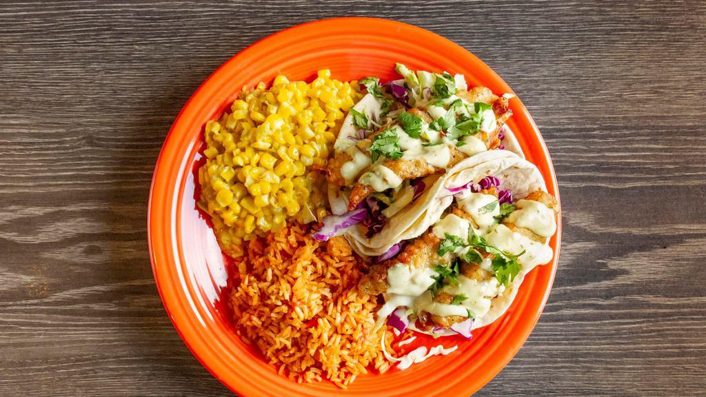Baja Fish Tacos · Dos XX beer-battered tilapia, fried crisp and folded into your choice of soft corn or flour tortillas; shredded cabbage, creamy tomatillo sauce.