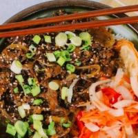 Bulgogi Beef W/White Rice · Tender shaved ribeye steak in a sweet sesame sauce tossed in garlic and sweet onions, topped...