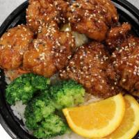 Honey Orange Sesame Chicken · Breaded cubes of white chicken breast tossed in honey, sesame, orange glaze with a side of b...