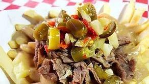 Poutine · Fries topped with white cheddar curds, Italian beef, gravy made from the beef jus, and giardiniera.