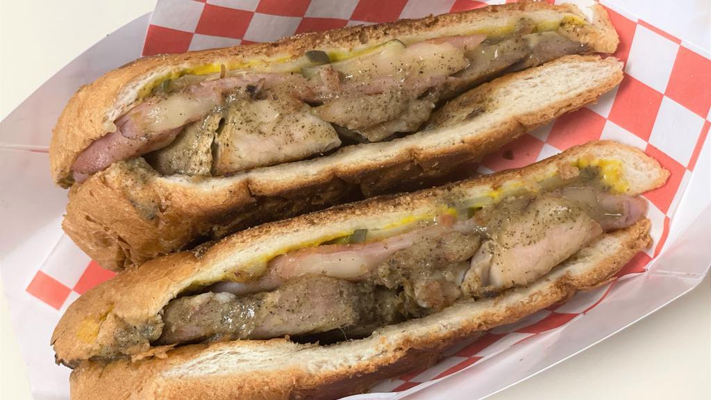 Cubano Sandwich · Slow-roasted pork with our specialty mojo sauce with smoked ham, Swiss, mustard, and pickles on a toasted pressed sub bun.