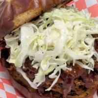Pulled Pork Sandwich · Slow-roasted pork with Stella's own spicy BBQ sauce on a bed of coleslaw. Served on burger b...