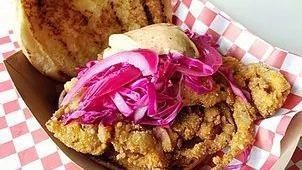 Soft-Shell Crab Sandwich · Crispy fried soft-shell crab topped with pickled red onion and cabbage slaw then dressed wit...