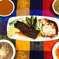 Tampiqueña · Broiled skirt steak, served with an enchilada, cebollitas and avocado. Served with Spanish r...