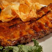 Bbq Baby Back Pork Ribs · Tender, slow roasted baby back ribs basted with our famous house BBQ sauce. Served with Clai...