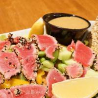 Sesame Ahi Tuna Salad · Seared rare ahi tuna served over romaine lettuce with diced tomatoes, edamame, sweet peppers...
