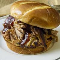 Pulled Pork Sandwich · Pulled Pork, topped with BBQ Sauce between two pieces of buttered Texas toast or Toasted Bri...