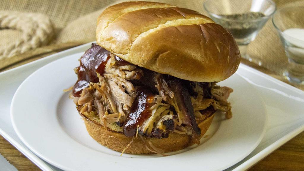 Pulled Pork Sandwich · Pulled Pork, topped with BBQ Sauce between two pieces of buttered Texas toast or Toasted Brioche Bun