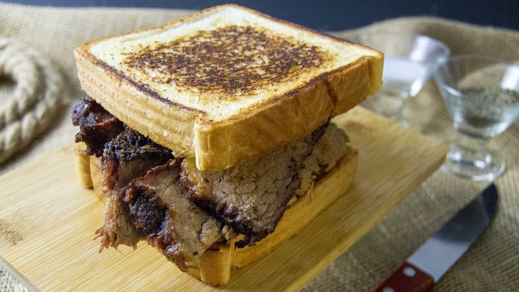 Beef Brisket Sandwich · Smoked Beef Brisket between two pieces of buttered Texas Toast or Brioche Bun, add BBQ sauce as an option.