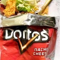 Walking Taco · 1.75 oz bag of Doritos topped with your choice of Beef, Steak or Chicken. Served with Lettuc...