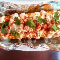 Mexican Street Corn · Corn on the cob topped with Sour Cream, Parmesan Cheese, Chili Powder and Cilantro.