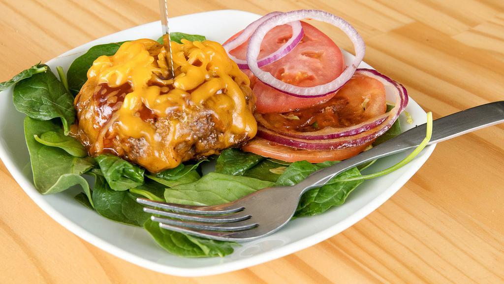 The Ace Burger · Grass fed burger grilled and basted in our house-made smoky chipotle barbeque sauce then topped with cheddar cheese romaine hearts, tomato and onion.