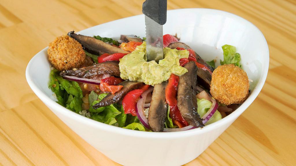 The Z Salad · Crisp green leaf lettuce served with our house vinaigrette. Topped with fire-roasted peppers, quinoa, goat cheese crumbles*, tomatoes, red onion, and grilled portabella mushrooms.