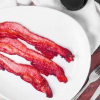 Side Premium Bacon · Three strips of premium thick-cut bacon.