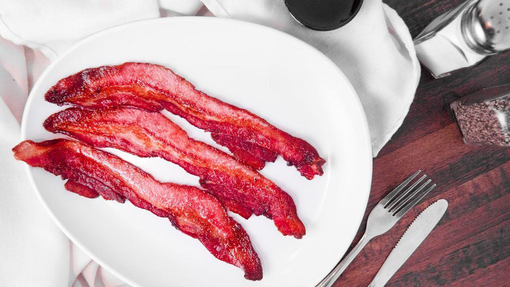 Side Premium Bacon · Three strips of premium thick-cut bacon.