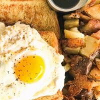 Whole Lotta Goodness · Two slices of french toast topped with a sausage patty, swiss cheese spread and a sunny side...