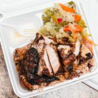 Jerk Chicken White · Served with bread, sauce, fried plantains, steamed cabbage, rice and beans.