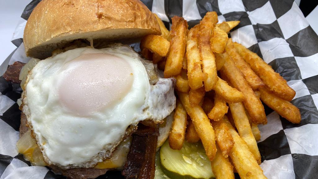 The Hangover Burger · 1/3 pounds fresh Angus beef served on butter roll with French fries. Colby jack cheese, smoked bacon, and buttery fried onions. Topped with a fried egg.