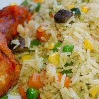 Fried Rice · Steamed rice cooked with mixed vegetables and unique seasonings. Served with plantains and c...
