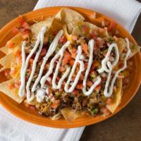 Loaded Nachos · Shredded cheese, beans, choice of chicken or beef served with pico de gallo, sour cream, hou...