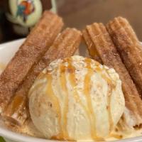 Churros · Four churro sticks sprinkled with cinnamon, sugar, and served with a scoop of vanilla ice cr...