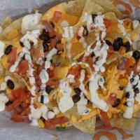 Loaded Nachos · Fried tortilla chips topped with black bean and corn salsa, pico de gallo, jalapenos, house ...