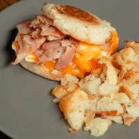 Breakfast Sandwich · Fried egg with ham and cheddar on an English muffin. Served with breakfast potatoes.
