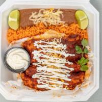 Enchilada Plate Combo Meal · 3 rolled tortillas dipped in red mole sauce, stuffed with your choice of meat, topped, with ...