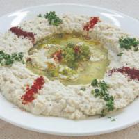 Baba Ghanouj · Smoked eggplant mixed with tahini sauce, spices and virgin olive oil.
