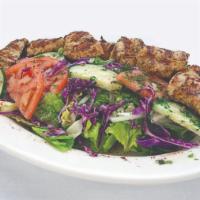 Grilled Chicken Salad · Grilled chicken breast, lettuce, tomatoes, and onions in a lemon vinaigrette dressing.