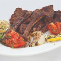 Lamb Chops · Savory lamb chops grilled to temperature served with grilled vegetables and our famous hummus.